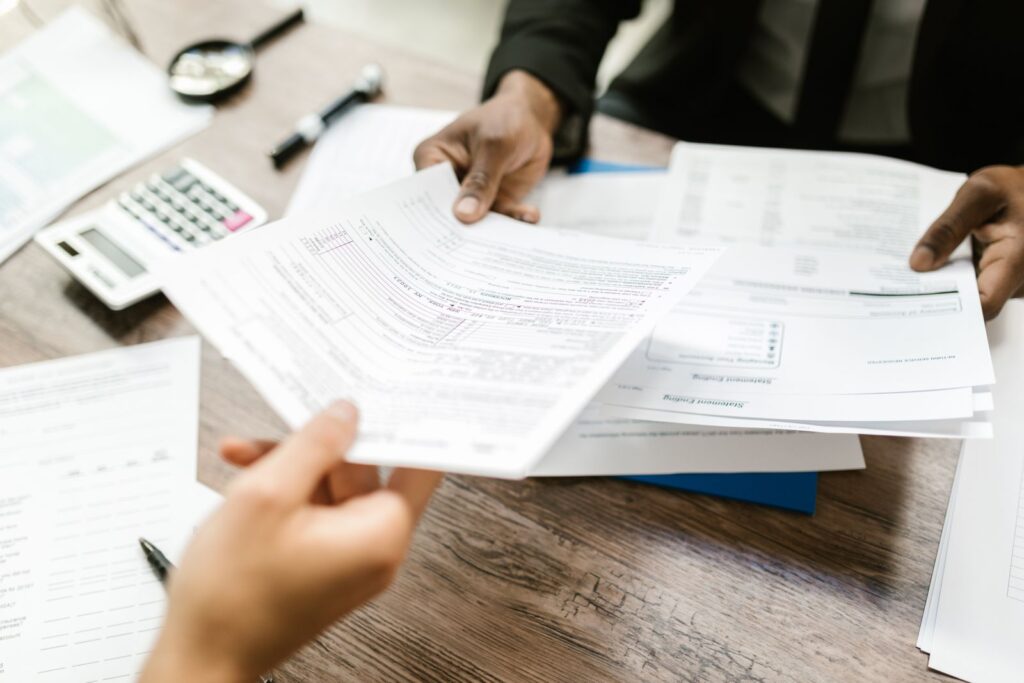 Dos personas revisando formularios de cobertura médica sobre un escritorio